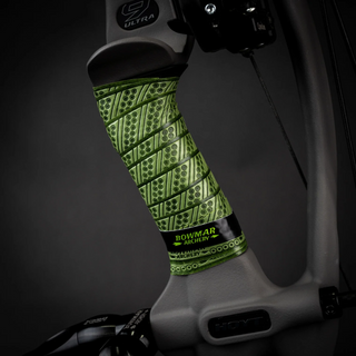 Green archery grip on a dark background