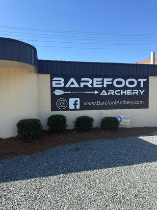 Barefoot Archery sign on side of building