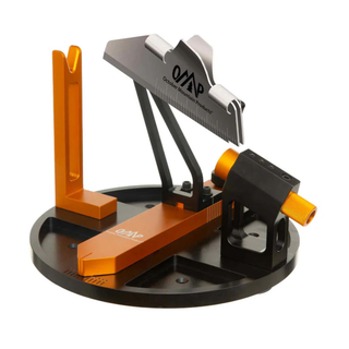 orange and black fletching jig on a white background