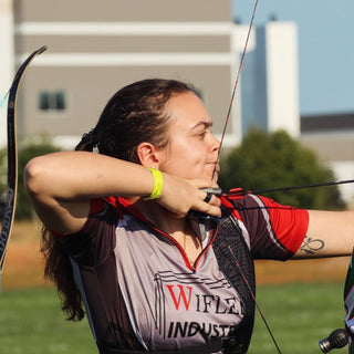 Olivia Martin Barefoot Archery Range Officer Coach drawing a bow
