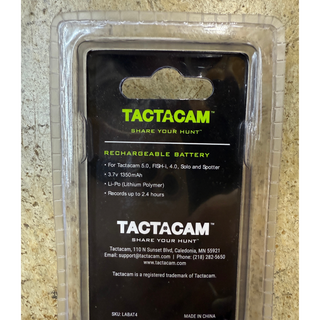 tactacam rechargeable battery in package, back view on concrete background