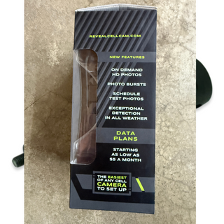 Tactacam reveal x camera in box, side view on concrete background