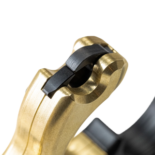 closeup of brass button release on a white background