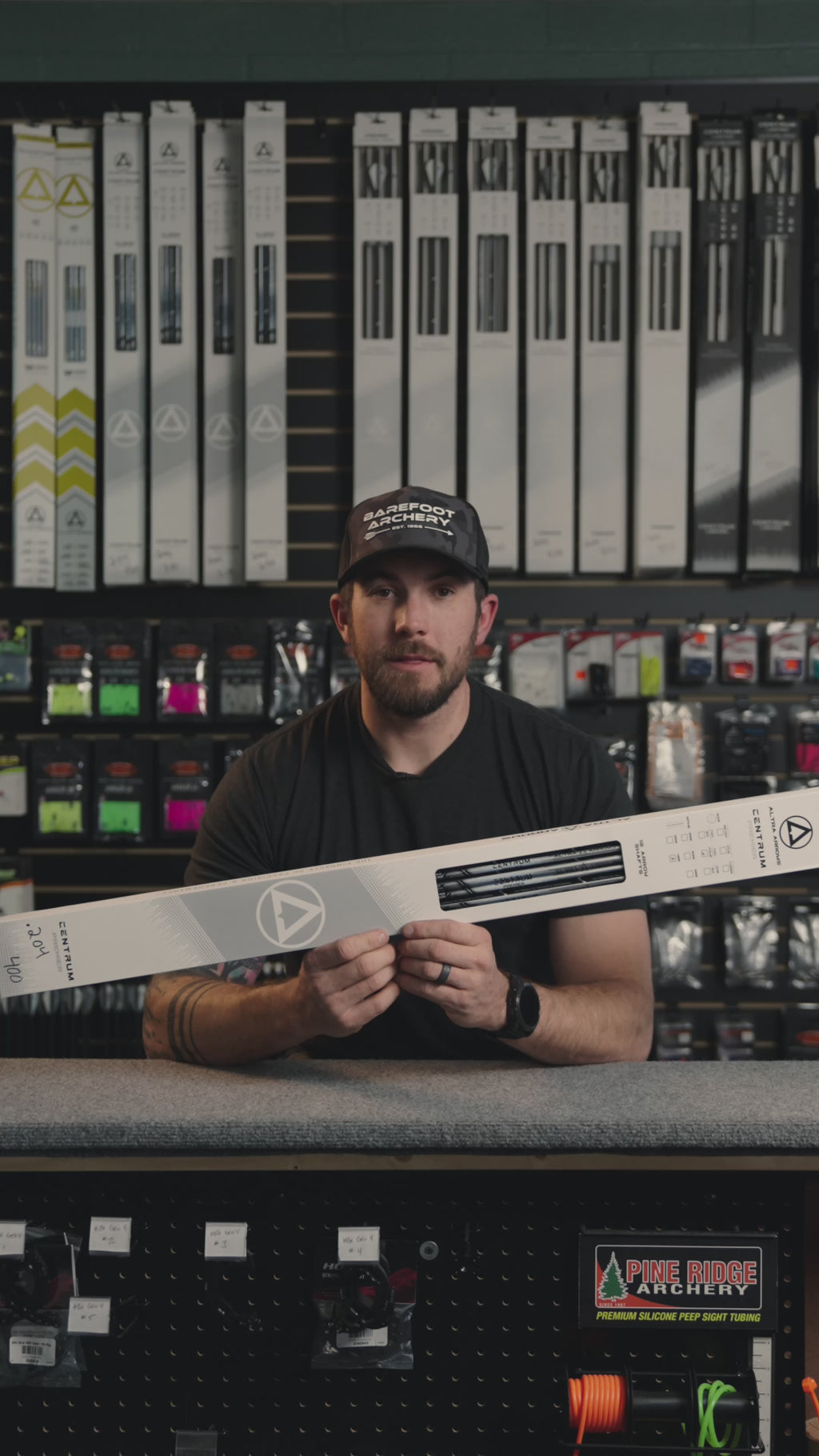 man behind the counter at an archery shop talking about the 204 Centrum Premier arrows