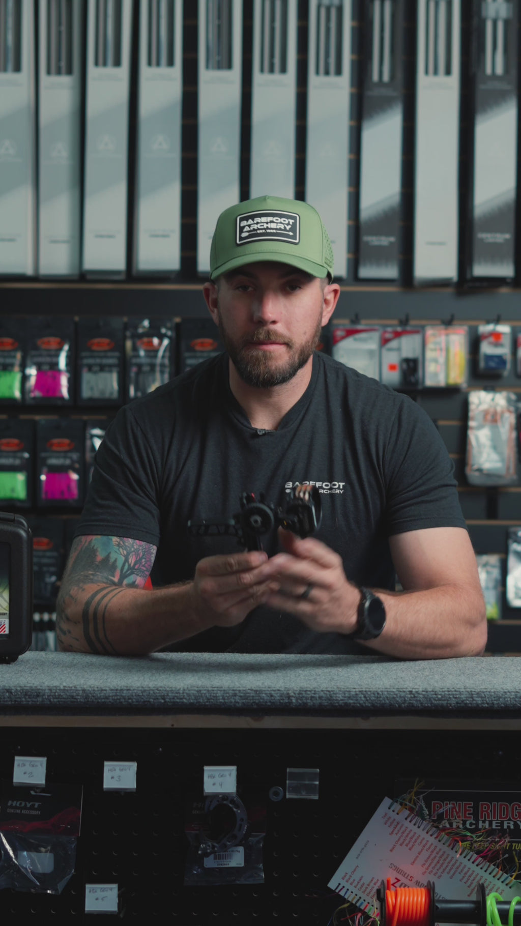 man behind the counter at an archery shop talking about the Driver by Axcel