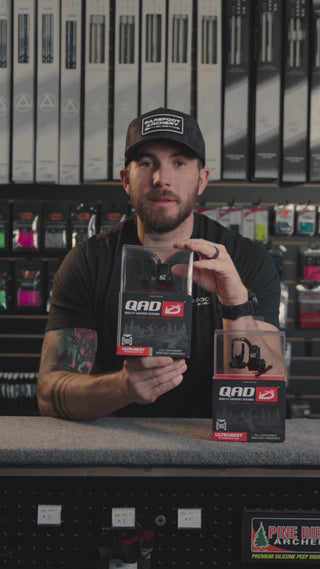 man in an archery shop behind the counter talking about the QAD ultrarest R2