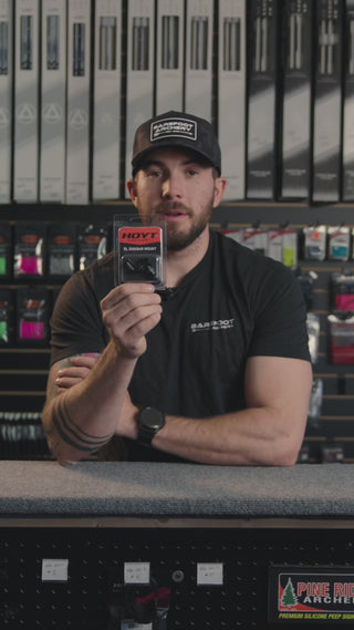 man in an archery shop behind the counter discussing the Hoyt SL sidebar mount