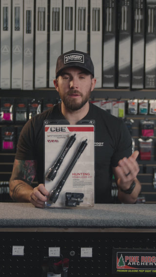 man in an archery shop behind the counter discussing the CBE hunting stabilizer kit
