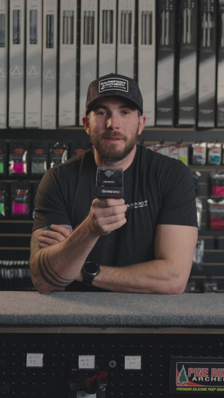 man in an archery shop behind the counter discussing the shrewd atlas vbar