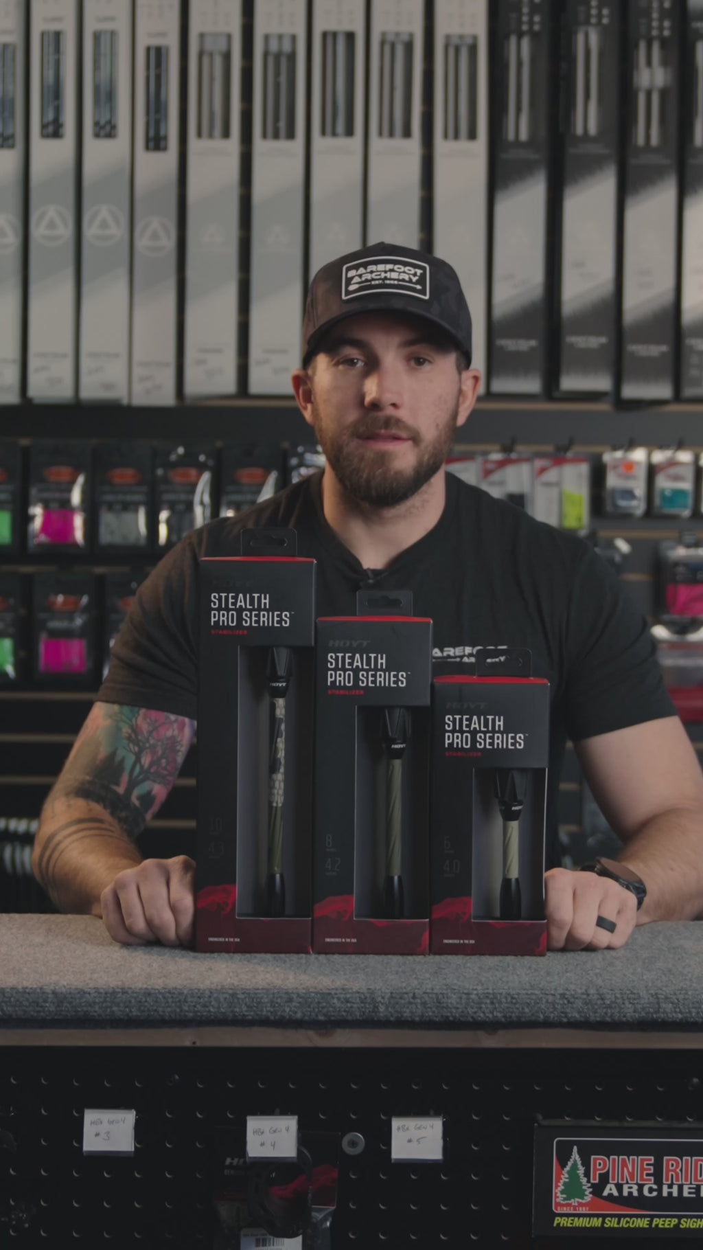 man in an archery shop behind the counter discussing Stealth Pro Series stabilizer