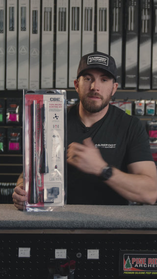 man in an archery shop behind the counter discussing the CBE torx micro hunting stabilizer kit