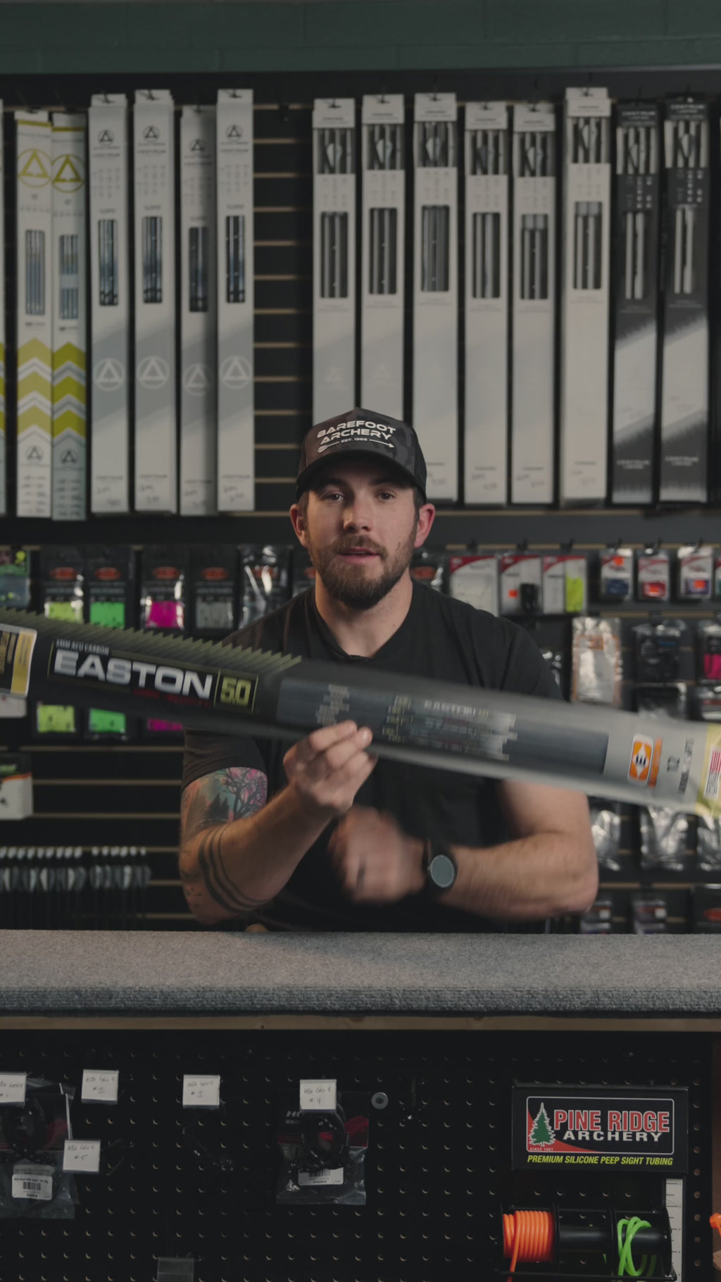 man behind the counter at an archery shop talking about Easton arrows