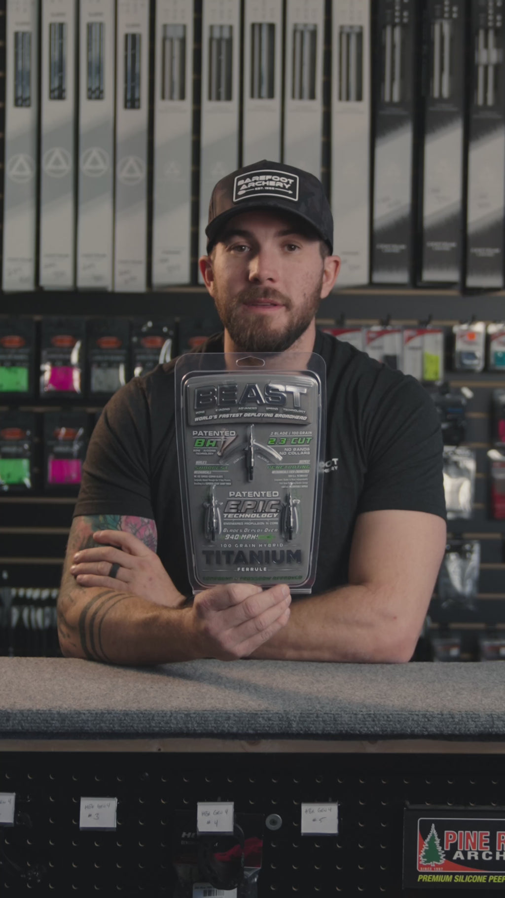 man in an archery shop behind the counter discussing the beast titanium broadheads