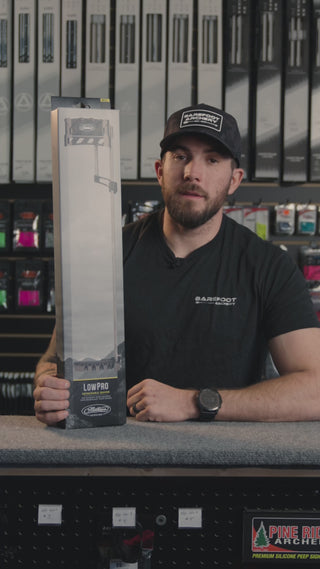 man at an archery shop behind the counter discussing the Mathews lowpro quiver