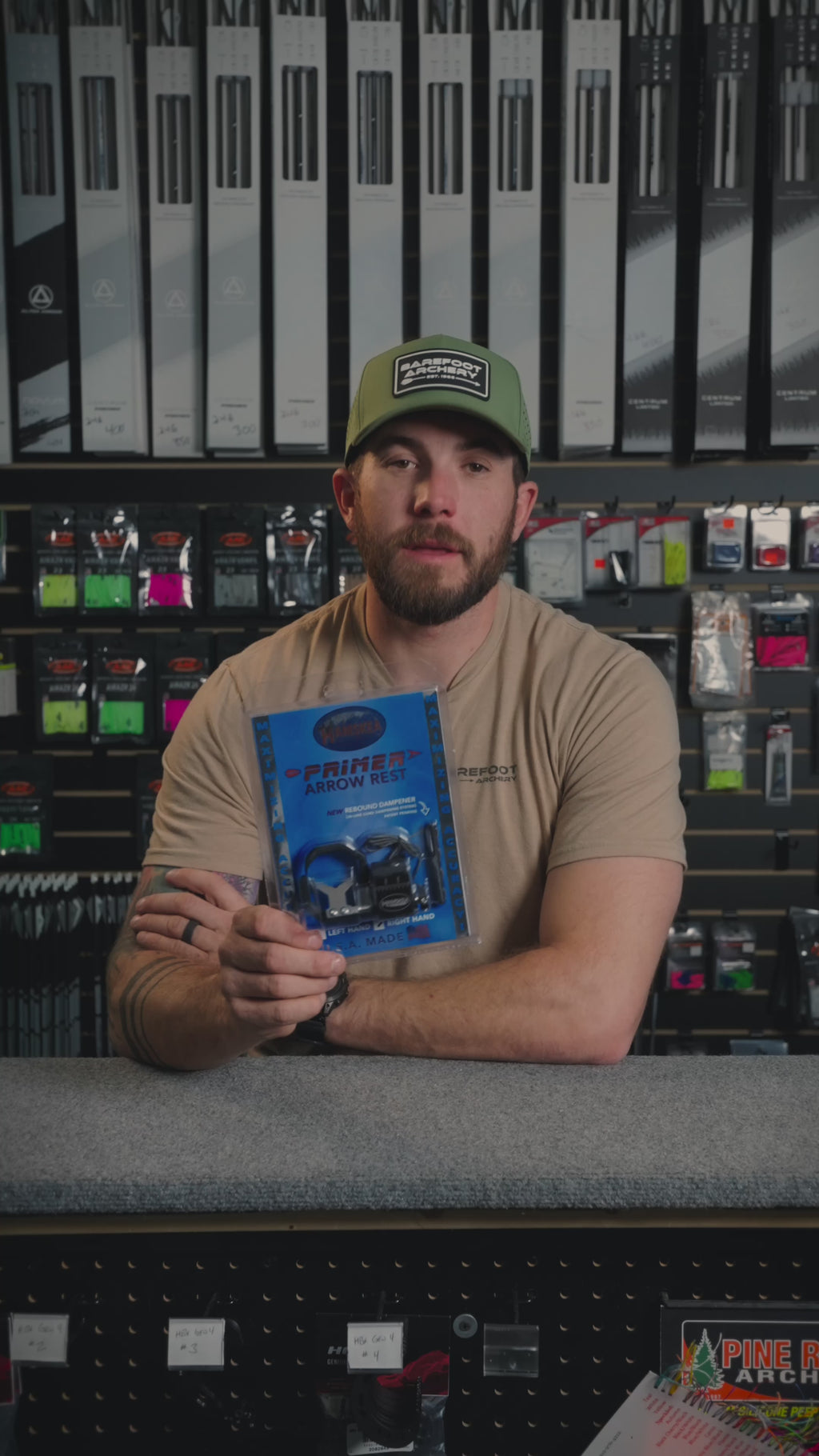 man behind the counter at an archery shop talking about the Primer Arrow Rest