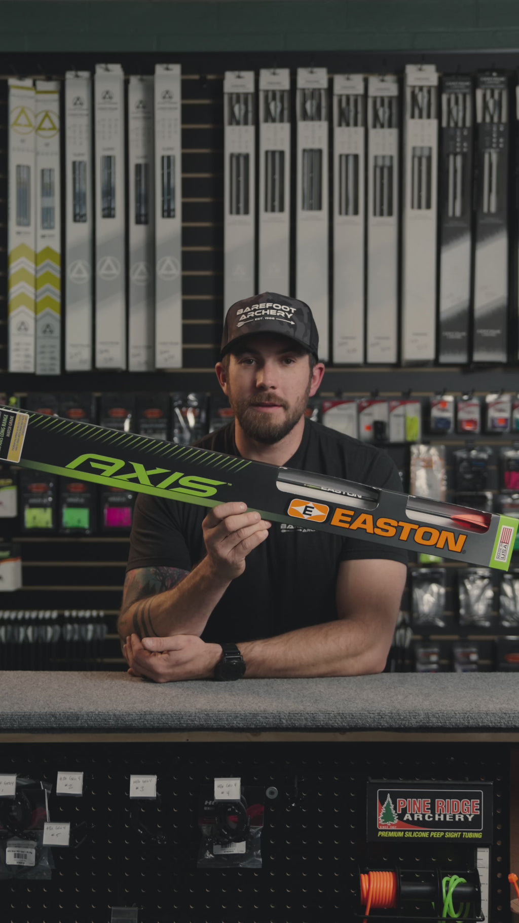 man behind the counter at an archery shop talking about Easton Axis longrange arrows